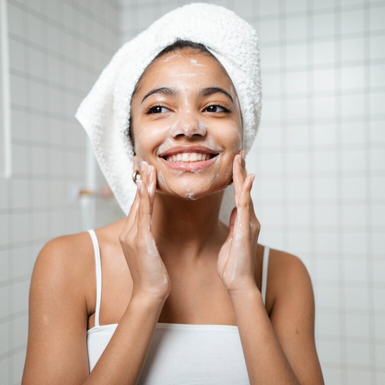 woman washing her face with bar soap